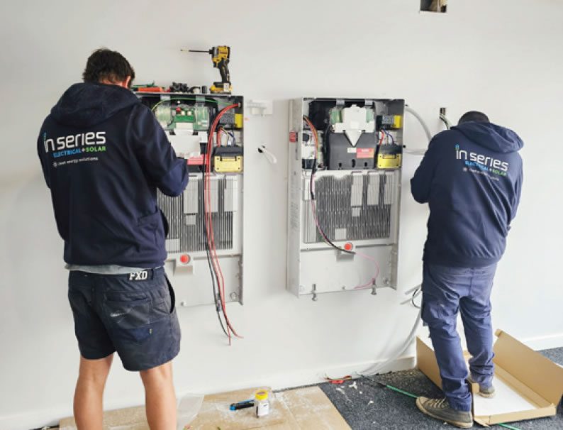 In Series technicians installing a home battery and switchboard upgrade