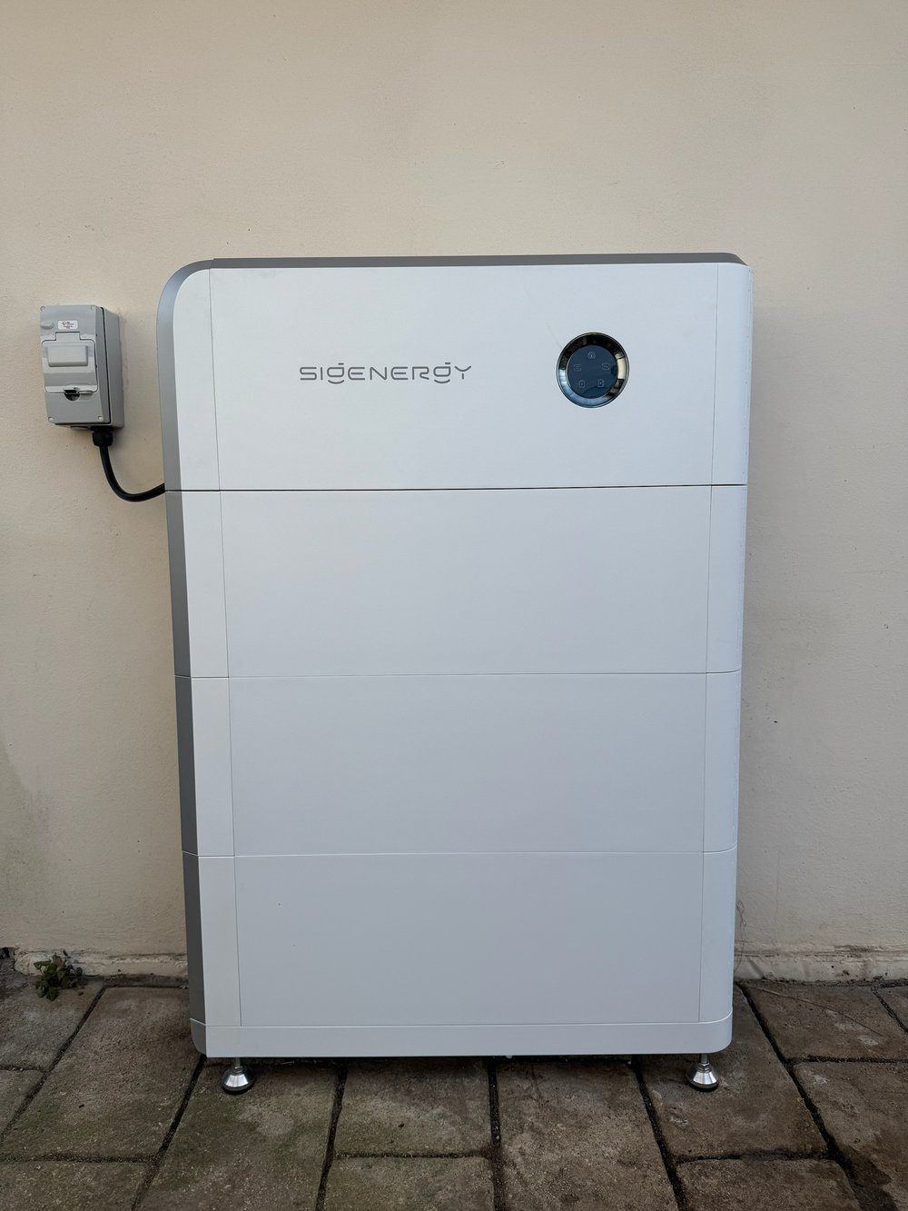 Sigenergy SigenStor home battery unit installed against an exterior wall