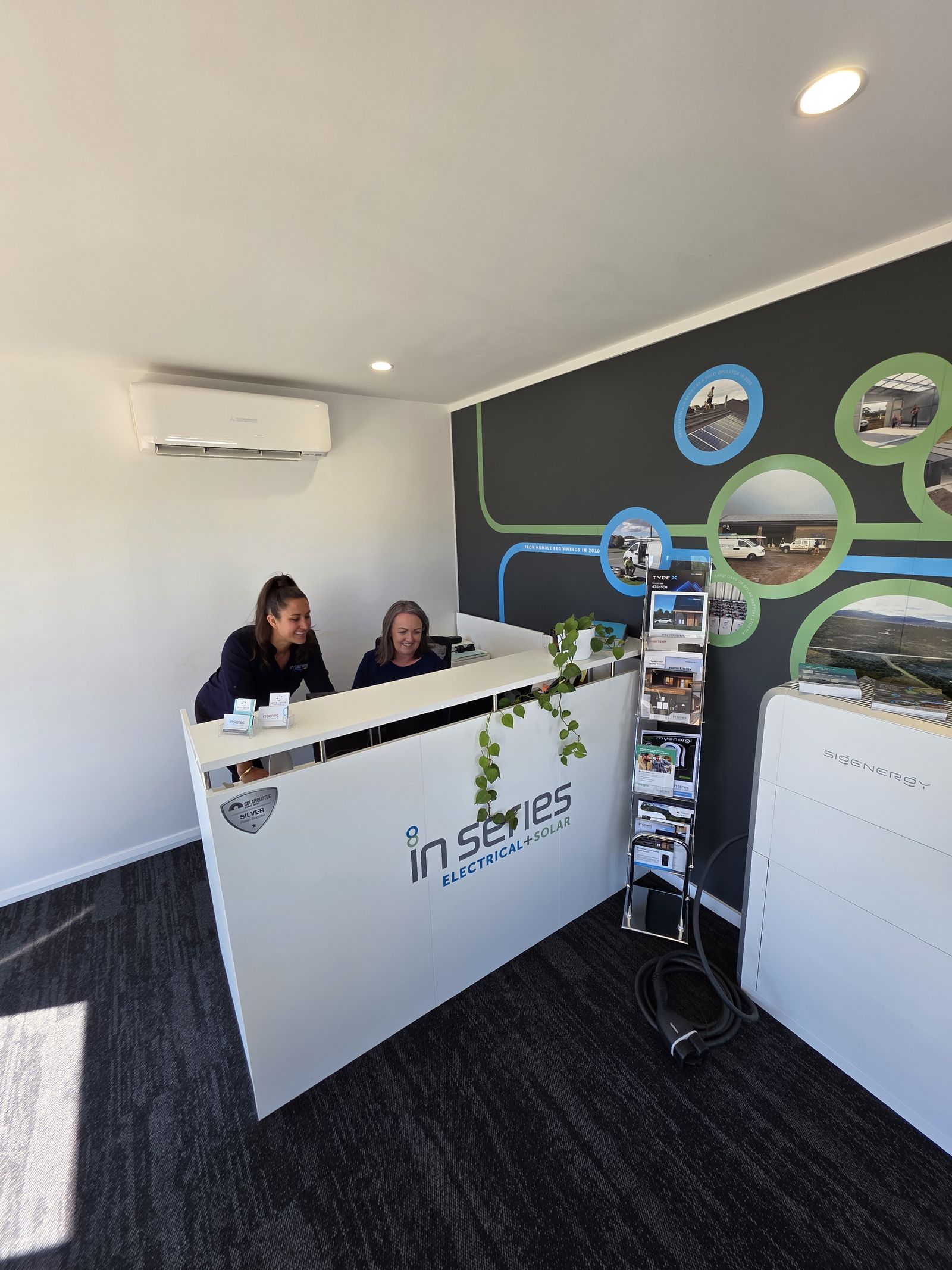 Kel and Sylv at the In Series office reception desk
